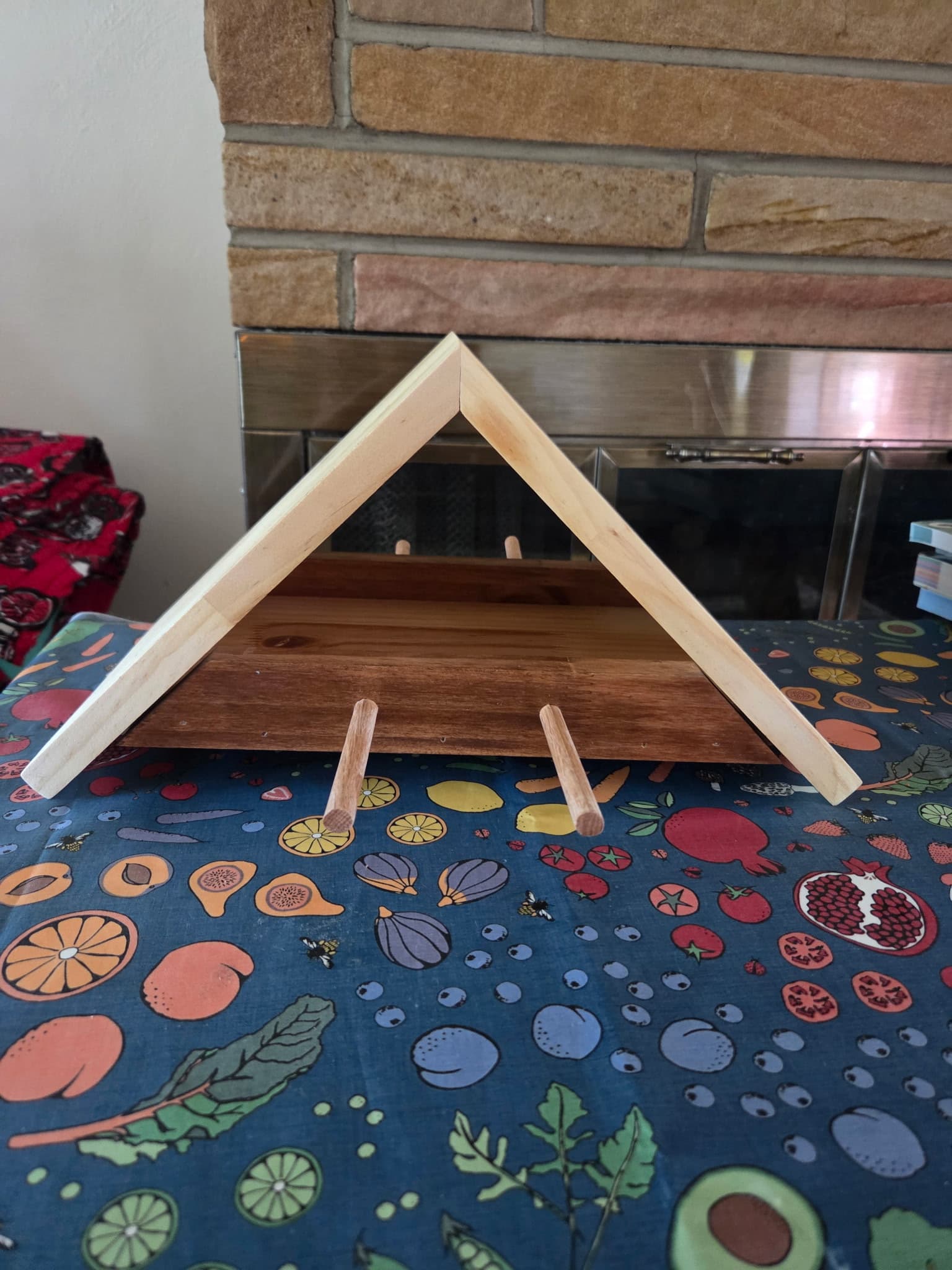 Small wooden A-frame piece with pegs